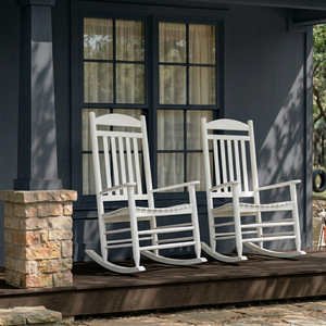 Two white teak and mahogany rocking chairs on a wooden deck in front of a house - Cambridge Casual