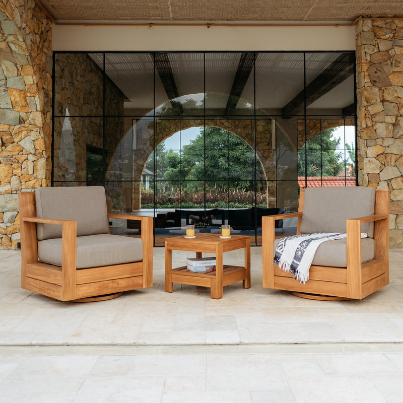 Outdoor patio set with wooden chairs and table on a stone patio.
