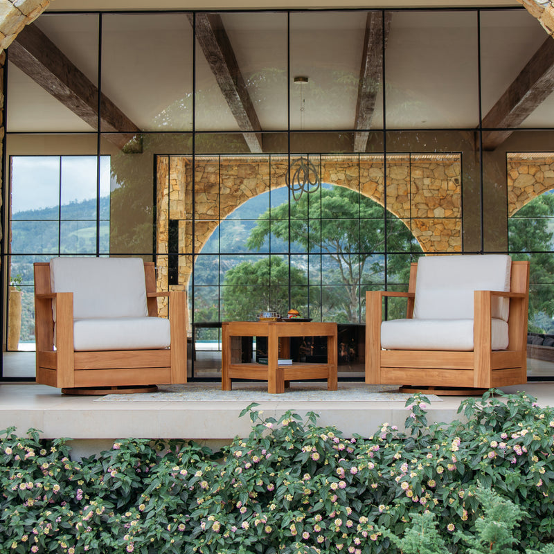 Wooden outdoor furniture set with white cushions in a scenic setting.